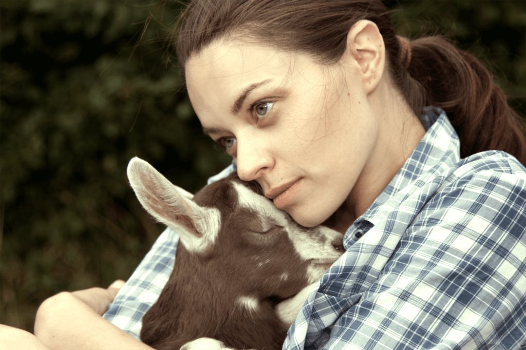 Woman Holding Baby Goat